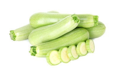 Photo of Fresh whole and cut zucchinis isolated on white, above view