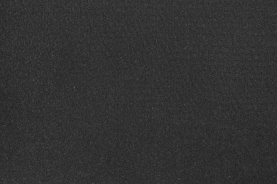 Texture of paper with dark gray ink as background, top view