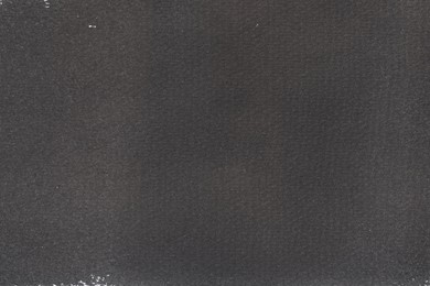 Photo of Texture of paper with dark gray ink as background, top view