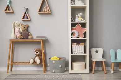 Photo of Stylish child room interior with modern furniture and toys