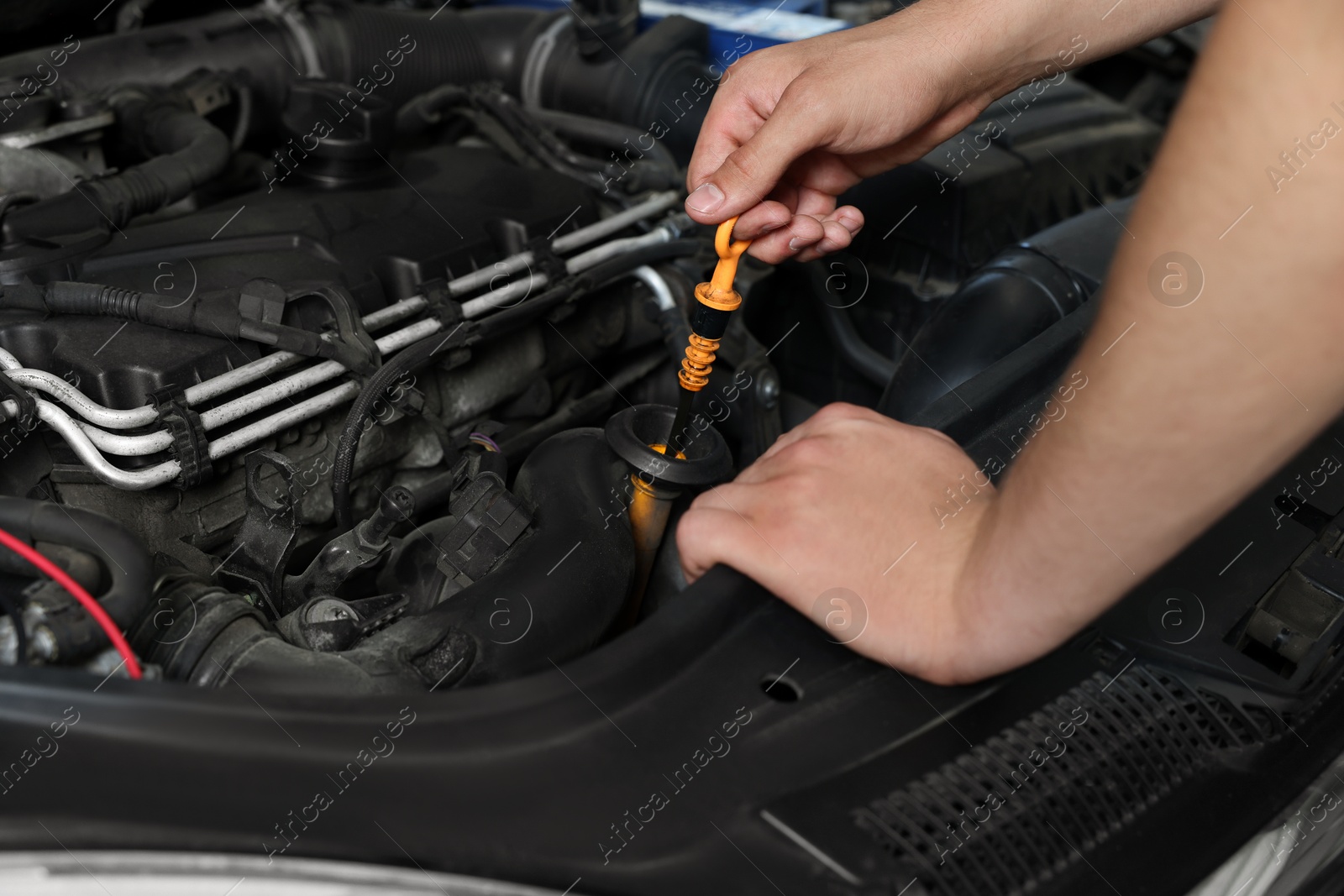 Photo of Auto mechanic fixing car at automobile repair shop, closeup