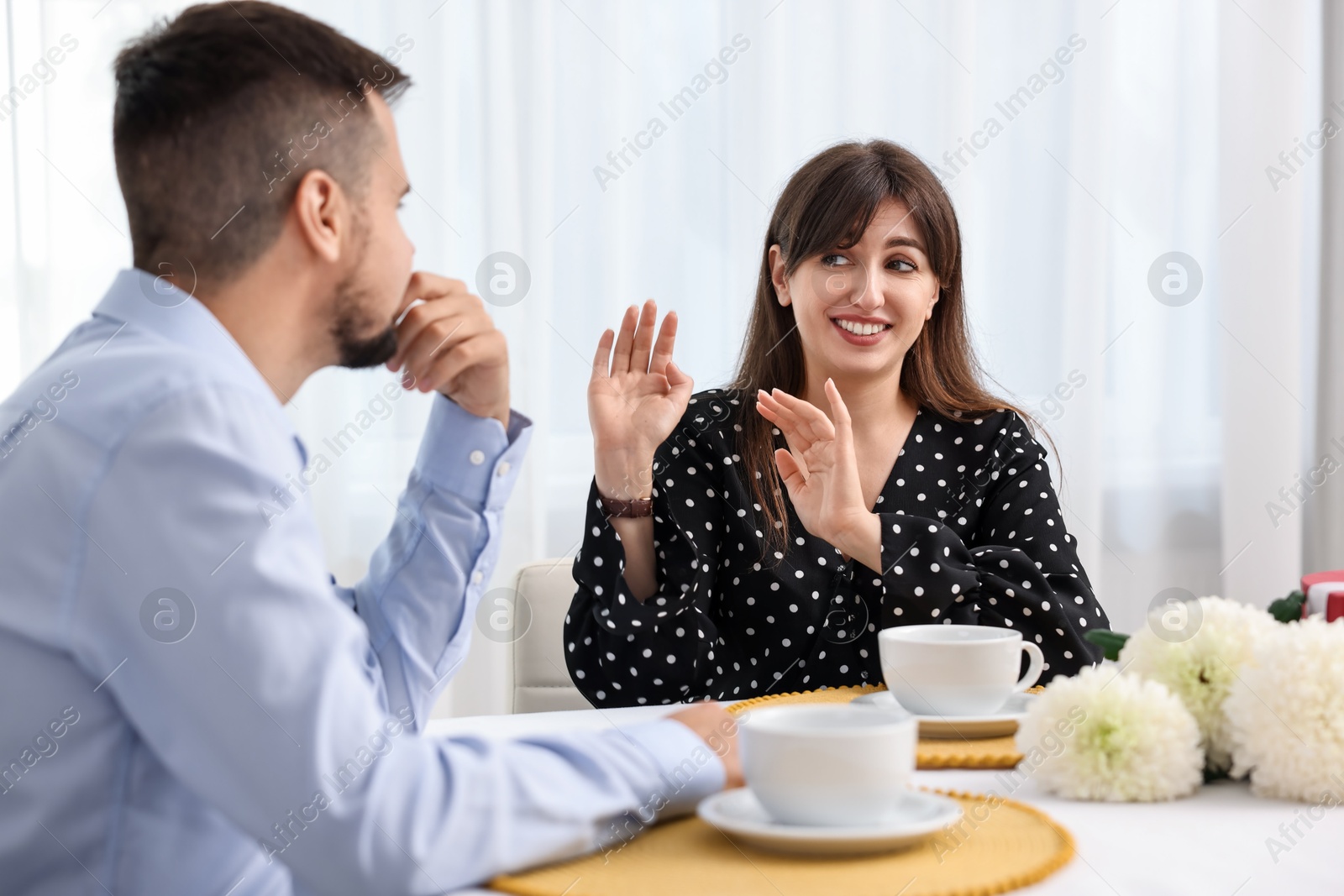 Photo of Couple on embarrassing date at table indoors