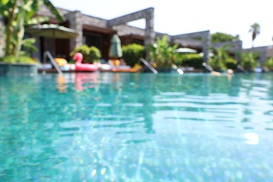 Blurred view of outdoor swimming pool at luxury resort