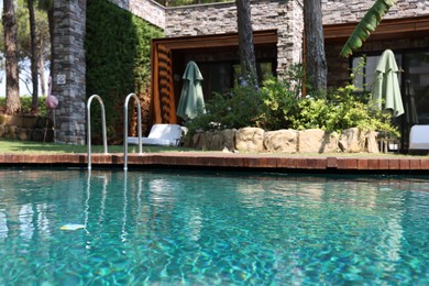 Photo of Outdoor swimming pool with clear water at luxury resort