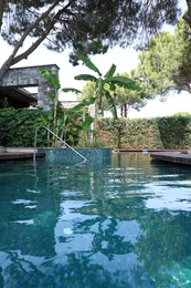 Outdoor swimming pool with clear water at luxury resort