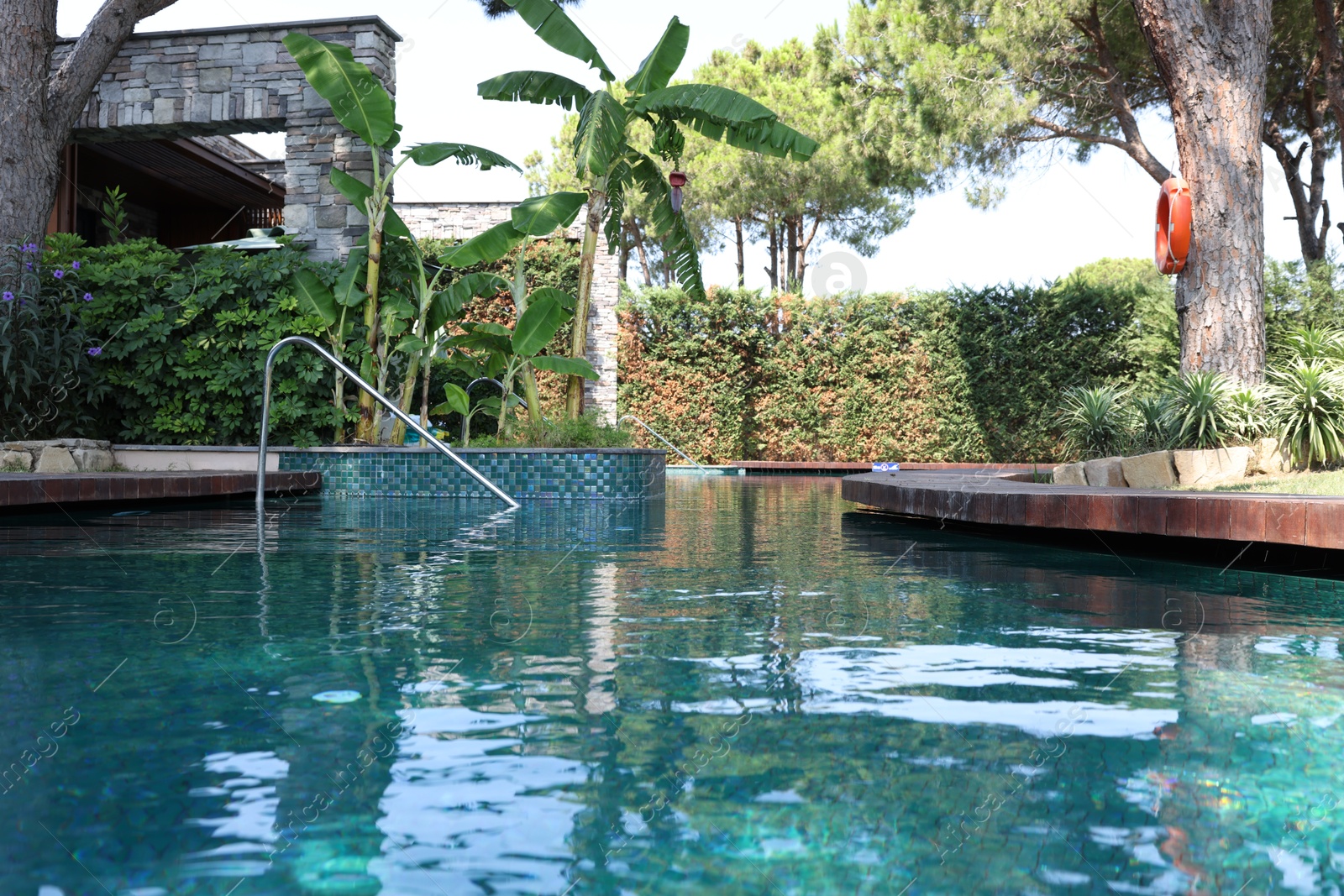 Photo of Outdoor swimming pool with clear water at luxury resort