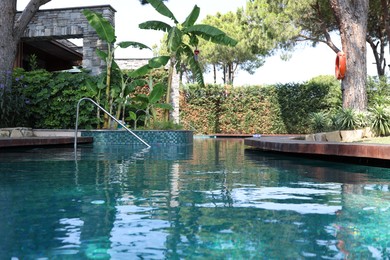 Photo of Outdoor swimming pool with clear water at luxury resort