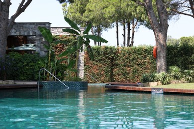 Outdoor swimming pool with clear water at luxury resort