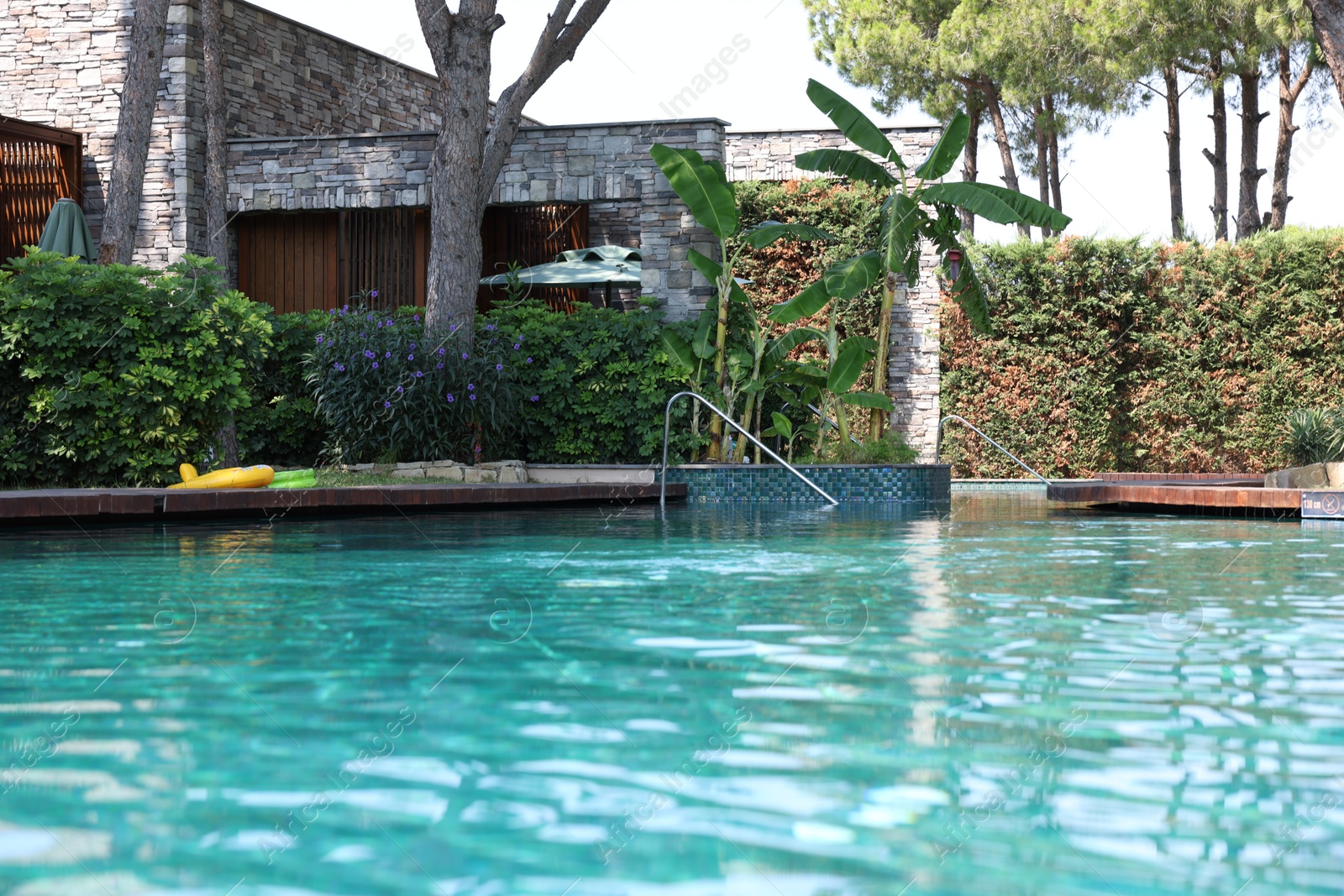 Photo of Outdoor swimming pool with clear water at luxury resort