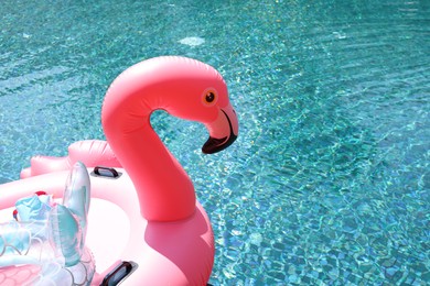 Inflatable float in shape of flamingo near outdoor swimming pool