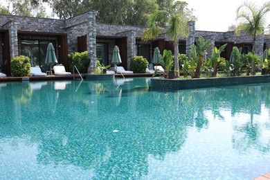 Photo of Outdoor swimming pool with clear water at luxury resort