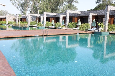 Photo of Outdoor swimming pool with clear water at luxury resort