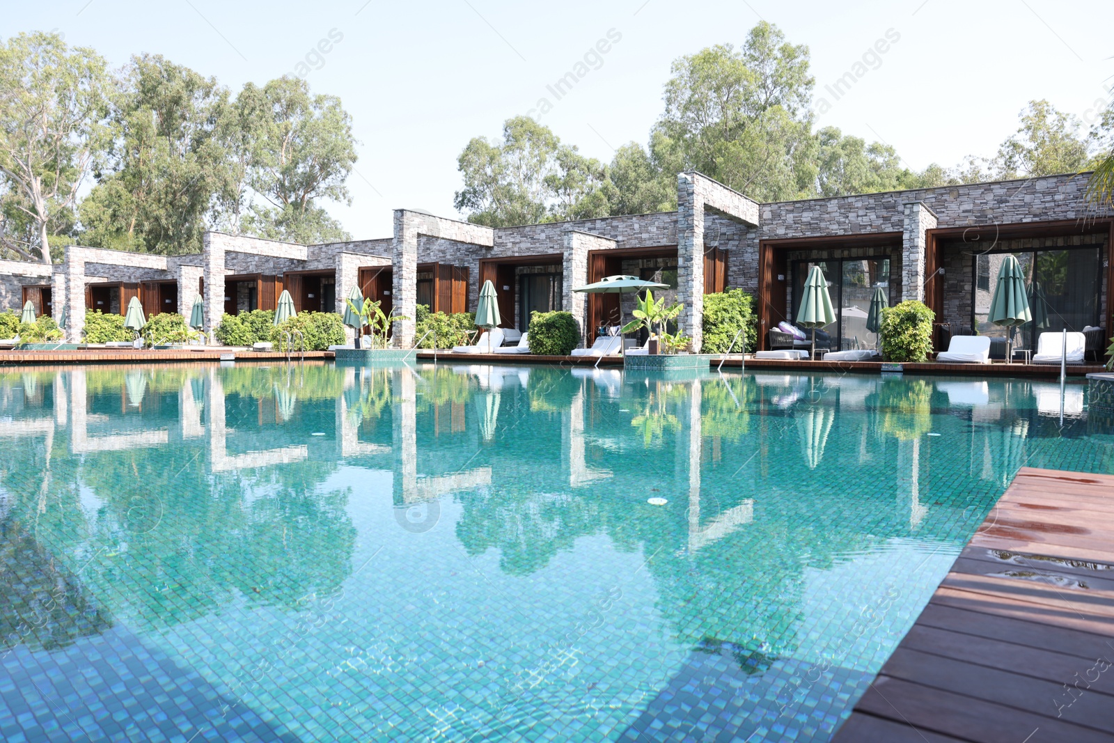 Photo of Outdoor swimming pool with clear water at luxury resort