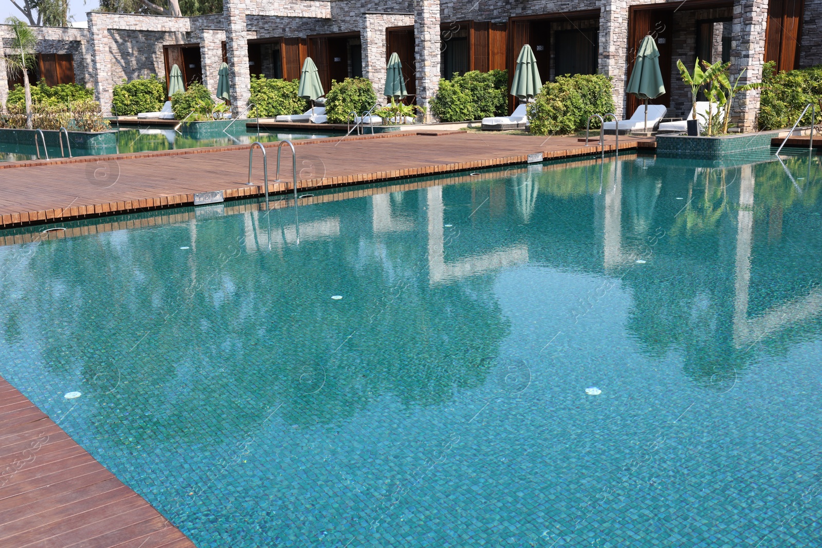 Photo of Outdoor swimming pool with clear water at luxury resort