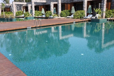 Outdoor swimming pool with clear water at luxury resort