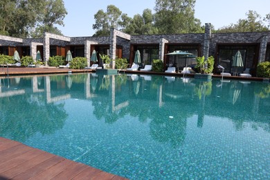 Photo of Outdoor swimming pool with clear water at luxury resort