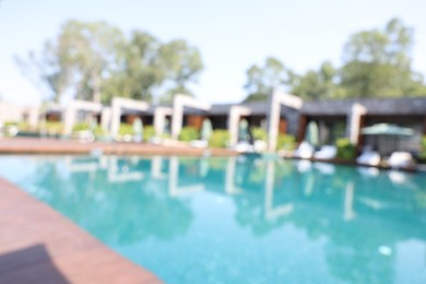 Blurred view of outdoor swimming pool at luxury resort