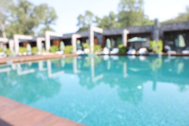 Blurred view of outdoor swimming pool at luxury resort