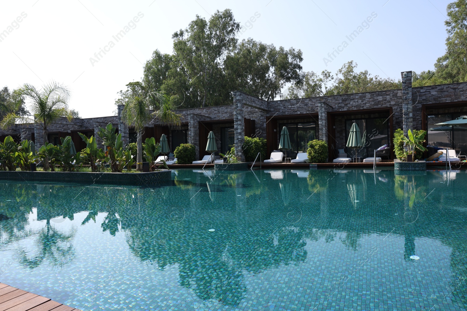 Photo of Outdoor swimming pool with clear water at luxury resort