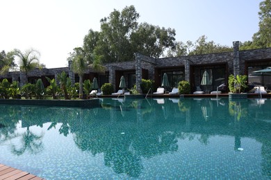 Photo of Outdoor swimming pool with clear water at luxury resort