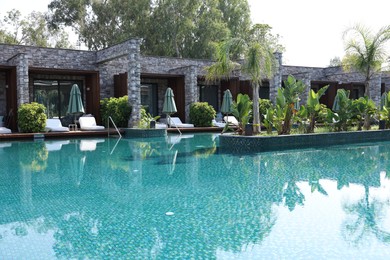 Outdoor swimming pool with clear water at luxury resort