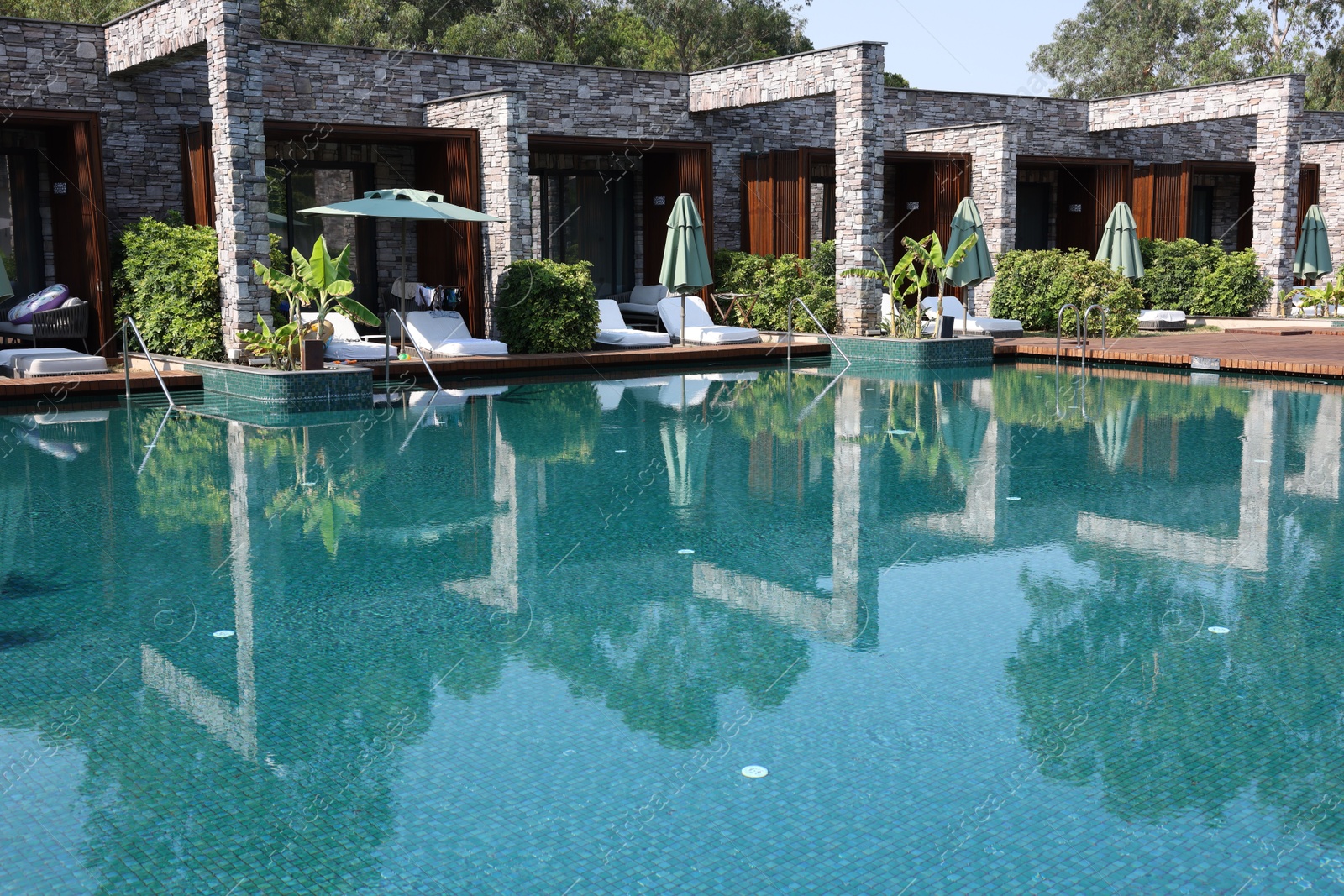 Photo of Outdoor swimming pool with clear water at luxury resort