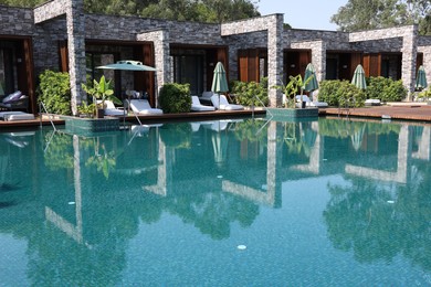 Outdoor swimming pool with clear water at luxury resort