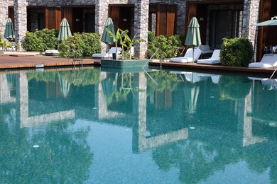 Outdoor swimming pool with clear water at luxury resort