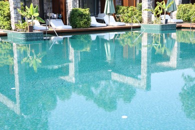 Outdoor swimming pool with clear water at luxury resort