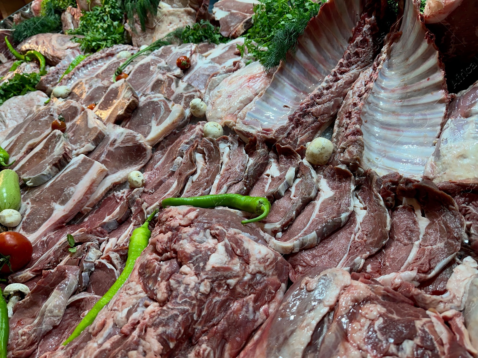 Photo of Closeup view of fresh cut raw meat and vegetables