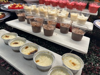 Photo of Different tasty desserts on table. Buffet service