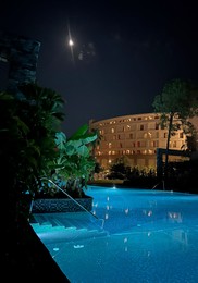 Beautiful view of swimming pool near luxury hotel at night