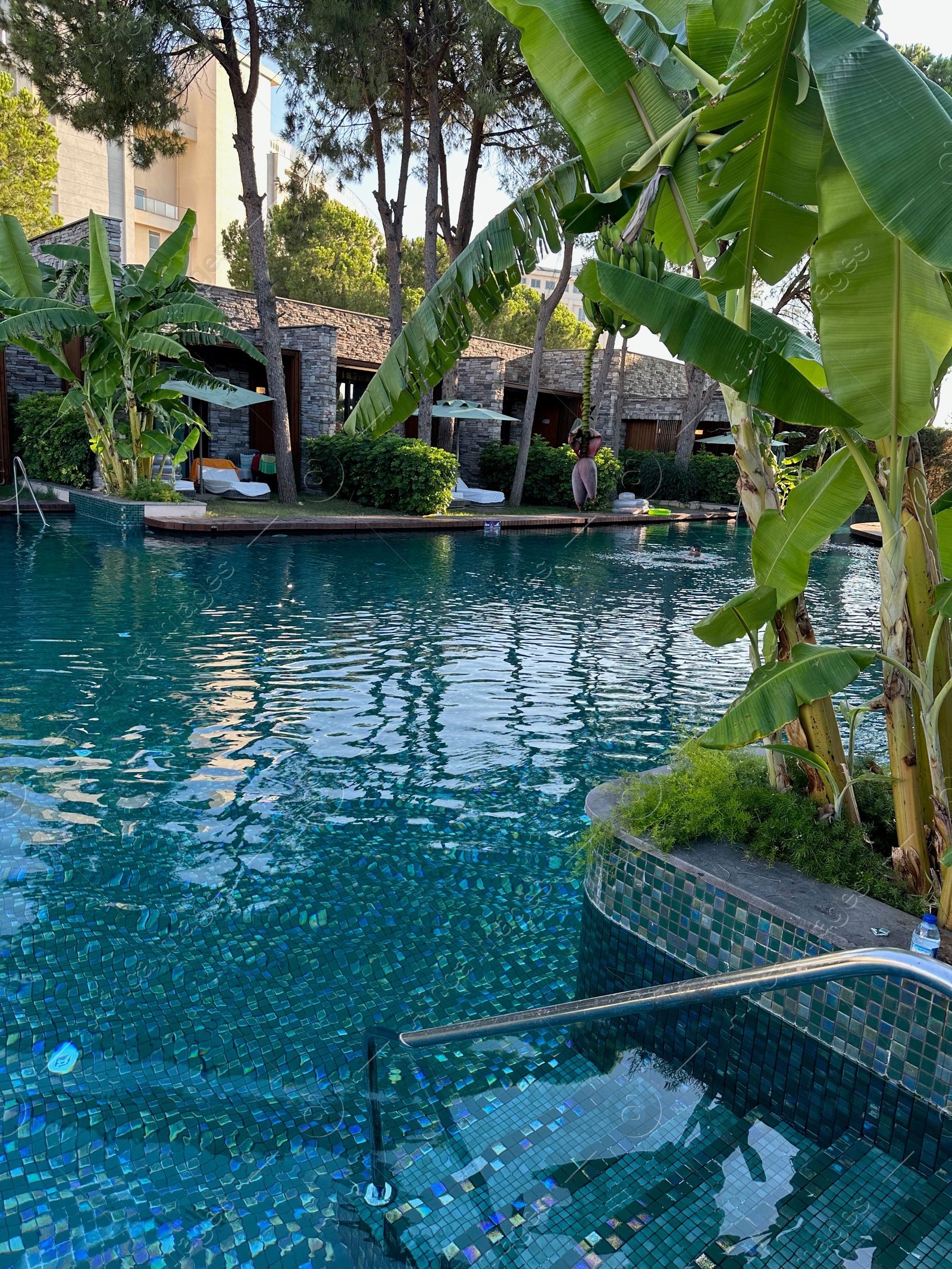 Photo of Outdoor swimming pool with clear water at luxury resort