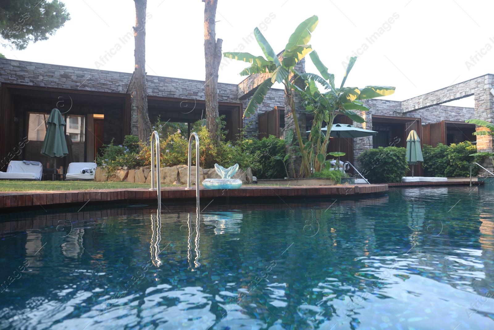 Photo of Outdoor swimming pool with clear water at luxury resort