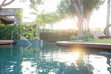 Photo of Outdoor swimming pool with clear water at sunset