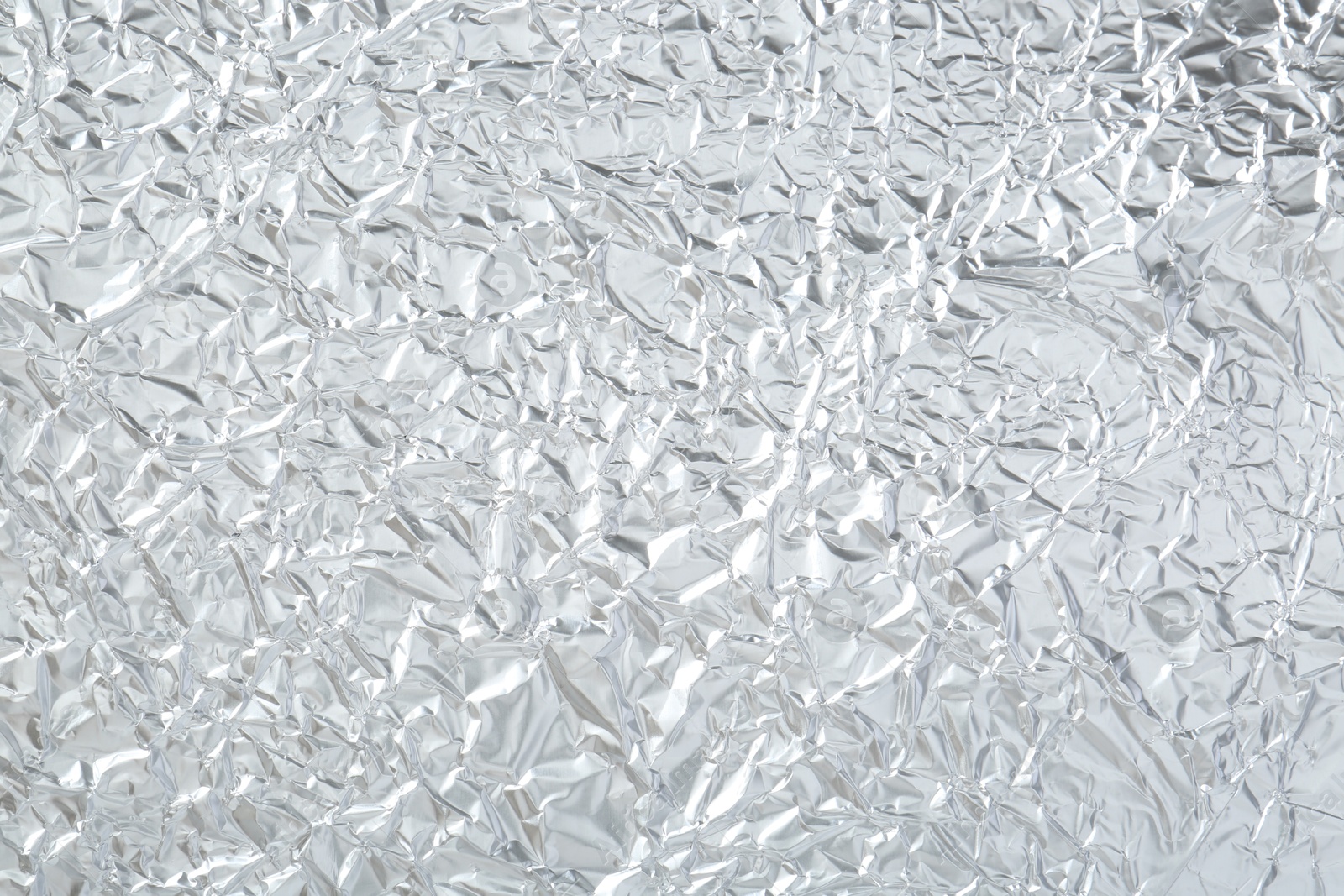 Photo of Shiny silver tinfoil surface as background, top view