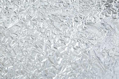 Shiny silver tinfoil surface as background, top view