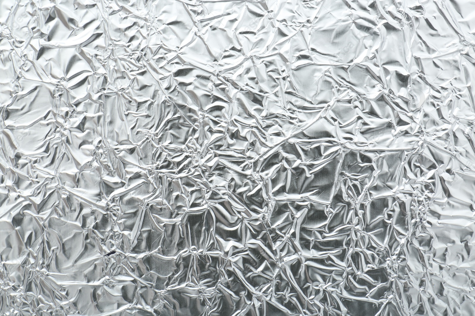 Photo of Shiny silver tinfoil surface as background, top view