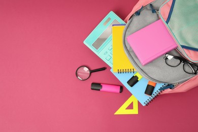 Photo of Backpack and different school supplies on pink background, flat lay. Space for text