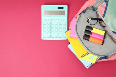 Photo of Backpack and different school supplies on pink background, flat lay. Space for text