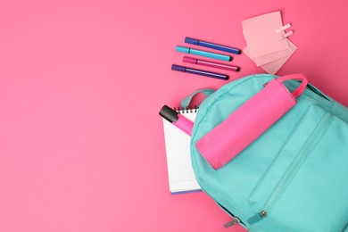 Photo of Backpack and different school supplies on pink background, flat lay. Space for text