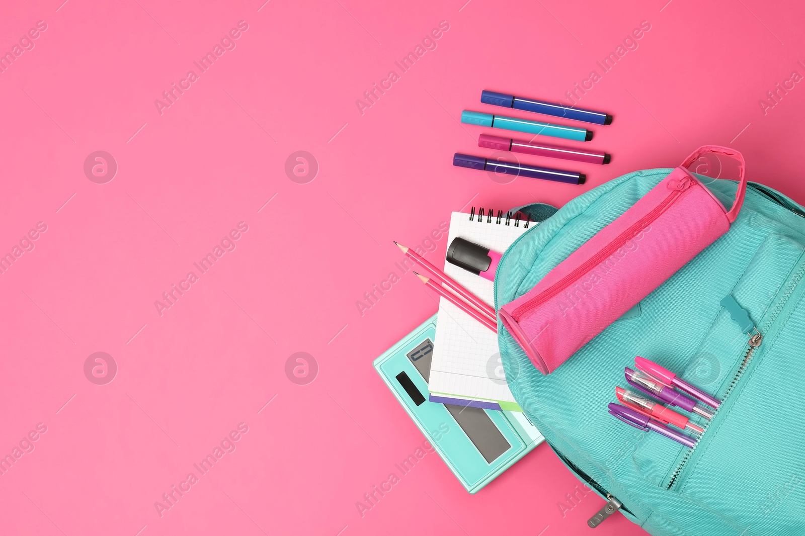 Photo of Backpack and different school supplies on pink background, flat lay. Space for text