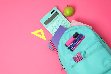 Photo of Backpack and different school supplies on pink background, flat lay. Space for text