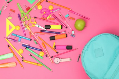 Photo of Backpack and different school supplies on pink background, flat lay