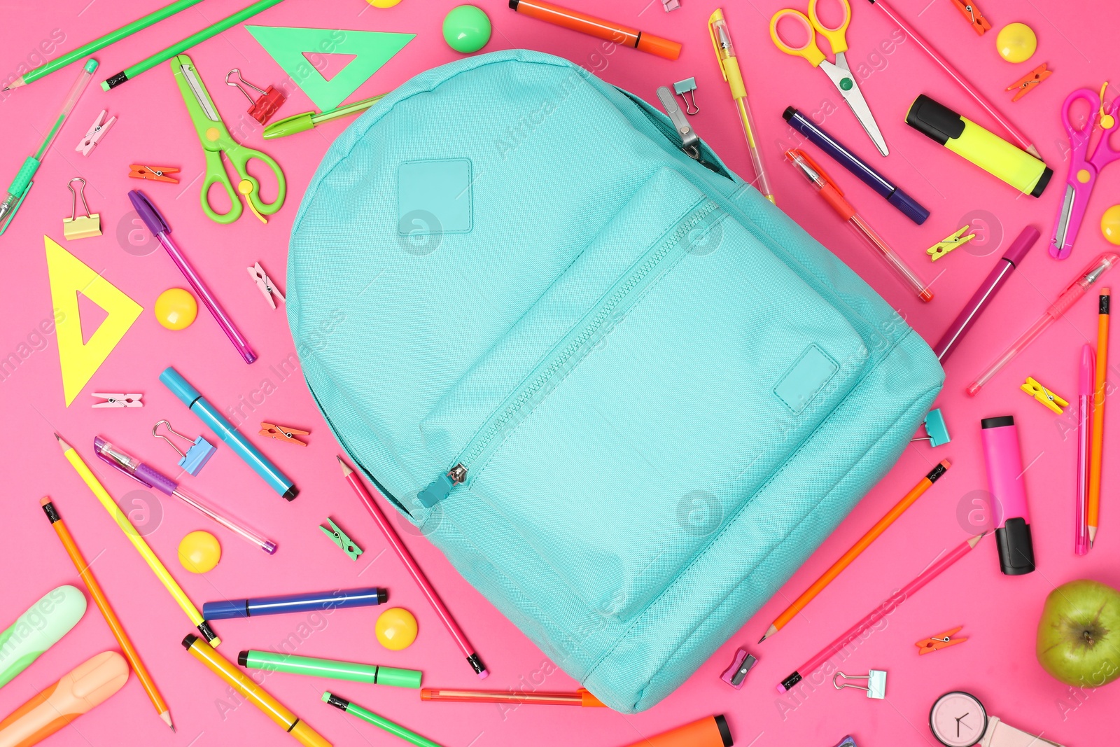 Photo of Backpack and different school supplies on pink background, flat lay