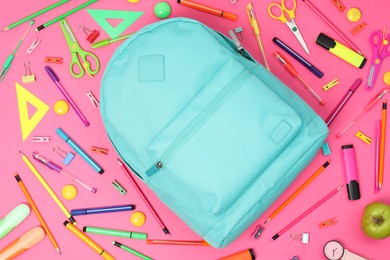 Photo of Backpack and different school supplies on pink background, flat lay