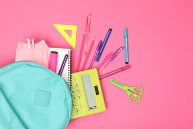 Photo of Backpack and different school supplies on pink background, flat lay. Space for text