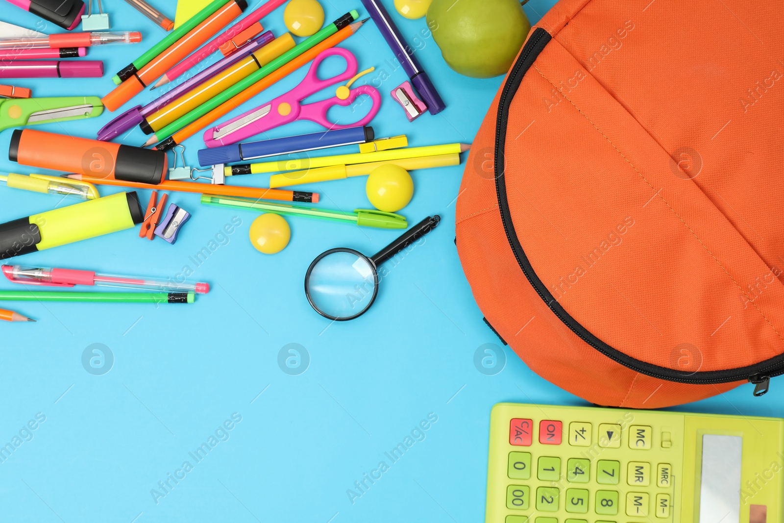 Photo of Backpack and different school supplies on light blue background, flat lay. Space for text