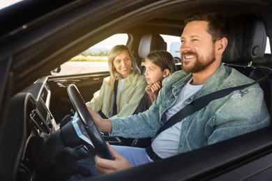 Image of Happy family enjoying trip together by car, view from outside