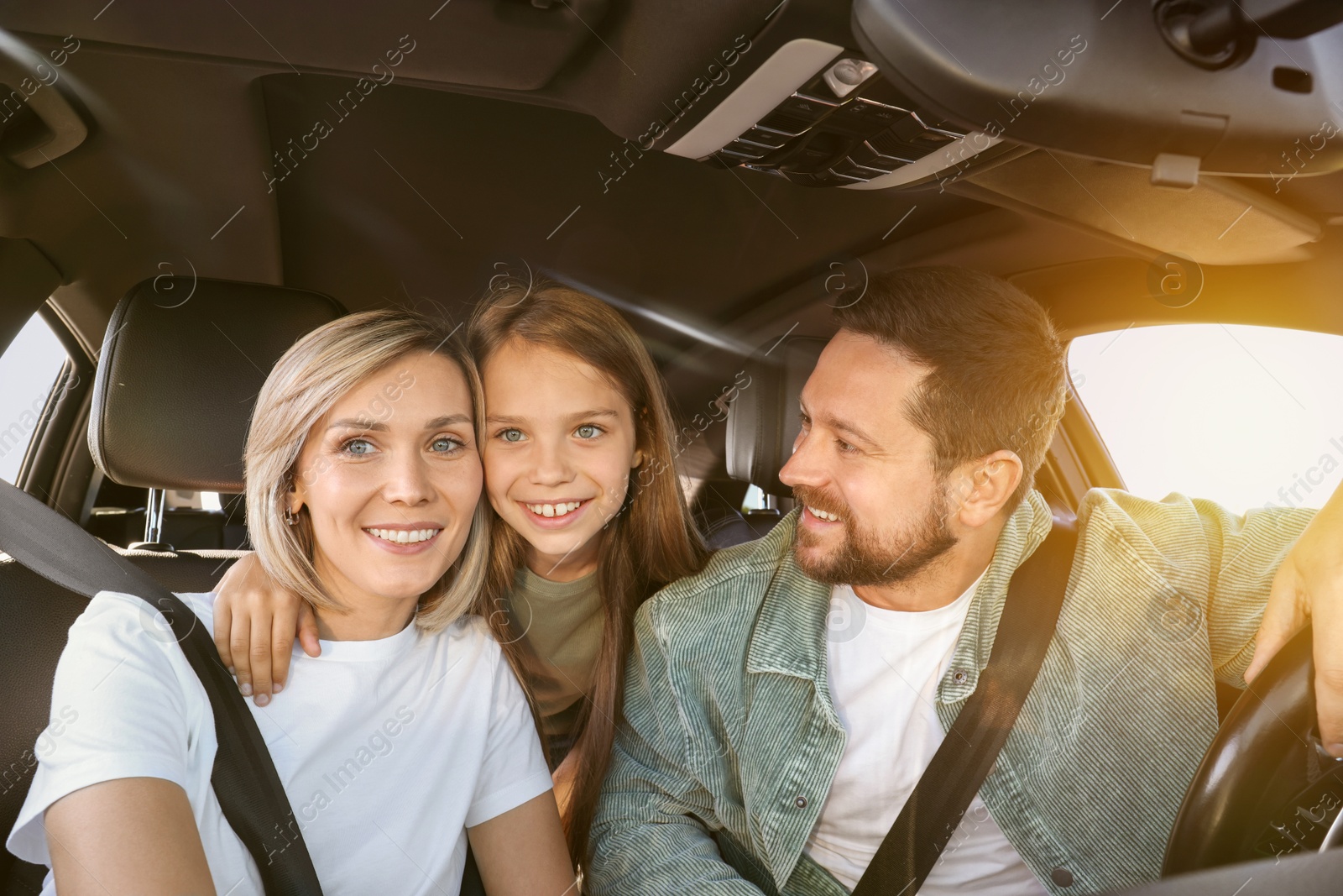 Image of Happy family on road trip. Parents with daughter in car